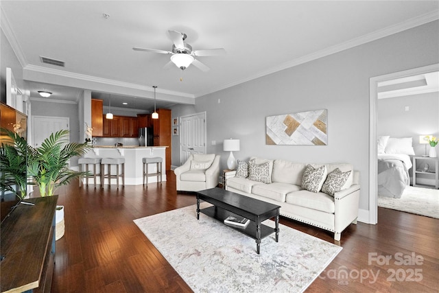 living room featuring crown molding, dark hardwood / wood-style floors, and ceiling fan