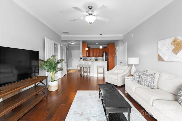 living room featuring ornamental molding, dark wood-type flooring, and ceiling fan