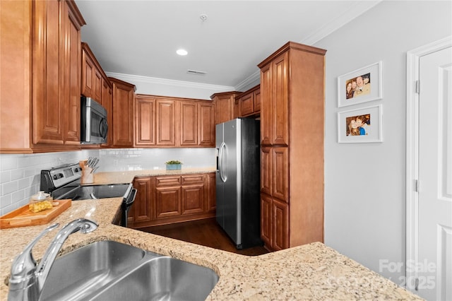 kitchen featuring sink, stainless steel appliances, and light stone countertops