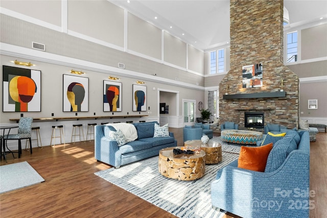 living room with a multi sided fireplace and hardwood / wood-style floors