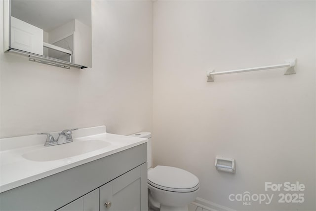 bathroom featuring vanity and toilet