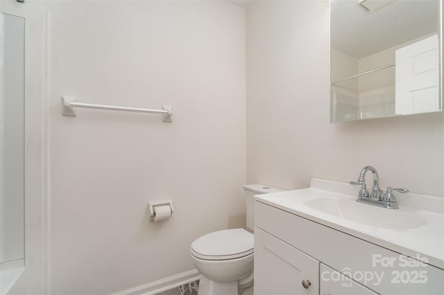 full bath with vanity, toilet, and baseboards