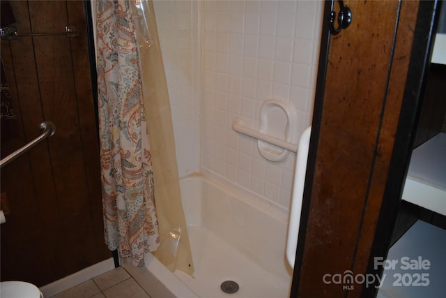 bathroom with walk in shower and tile patterned floors