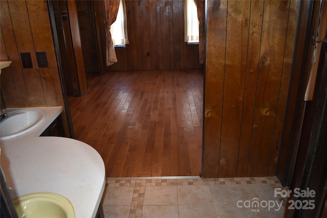 bathroom featuring vanity and wooden walls