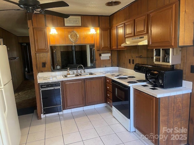 kitchen with light tile patterned flooring, sink, tile countertops, range with electric stovetop, and white fridge