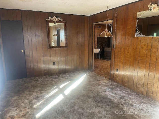 unfurnished room with carpet floors and wooden walls