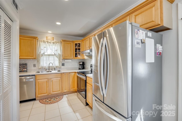 kitchen with stainless steel appliances, light tile patterned flooring, sink, and backsplash