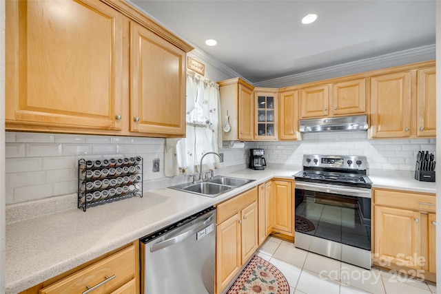 kitchen featuring sink, backsplash, light tile patterned floors, stainless steel appliances, and crown molding