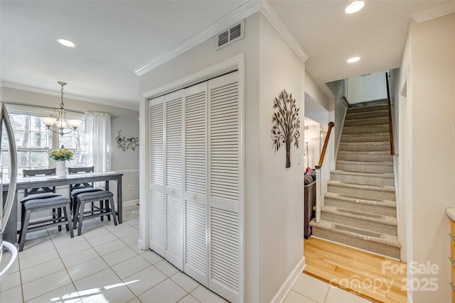 interior space featuring crown molding, light tile patterned floors, and a chandelier