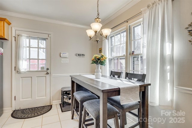 dining area with crown molding, plenty of natural light, light tile patterned flooring, and an inviting chandelier