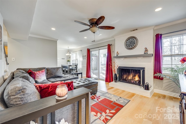 living room with hardwood / wood-style floors, crown molding, and plenty of natural light