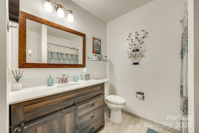 bathroom featuring vanity, tile patterned flooring, and toilet