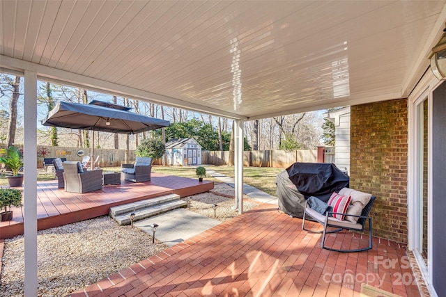 wooden terrace featuring outdoor lounge area, a grill, and a storage shed