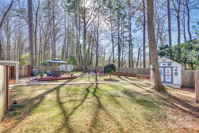 view of yard with a deck and a shed