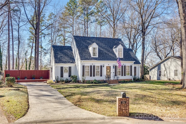 new england style home featuring a front yard