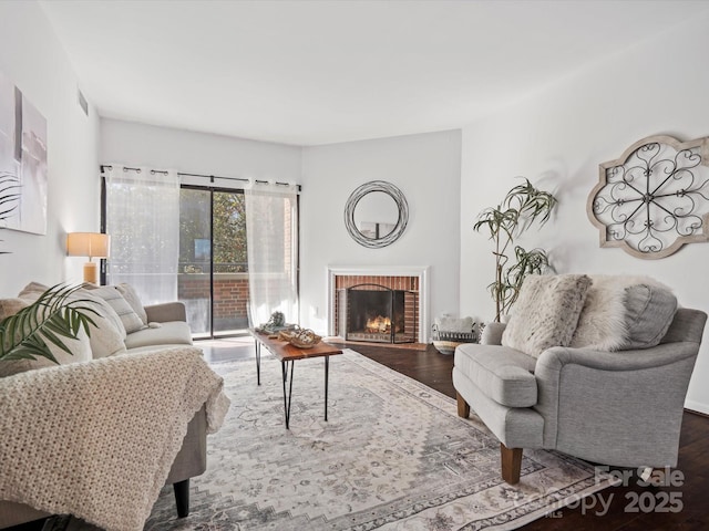 living room featuring hardwood / wood-style flooring and a fireplace