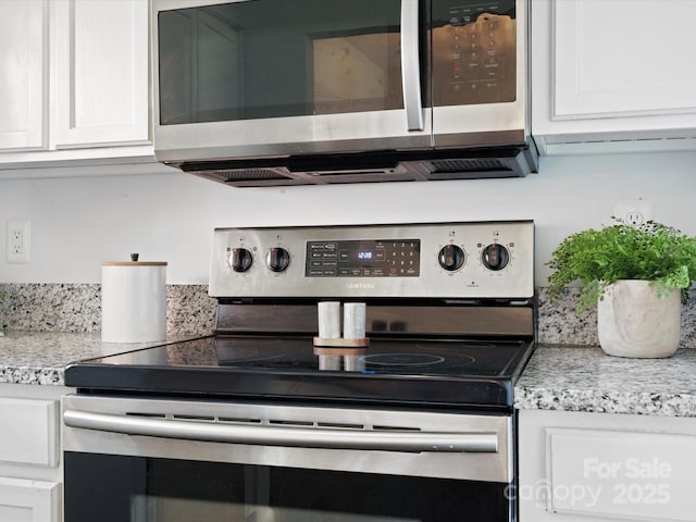 kitchen featuring white cabinetry and appliances with stainless steel finishes