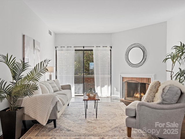 living room with a brick fireplace