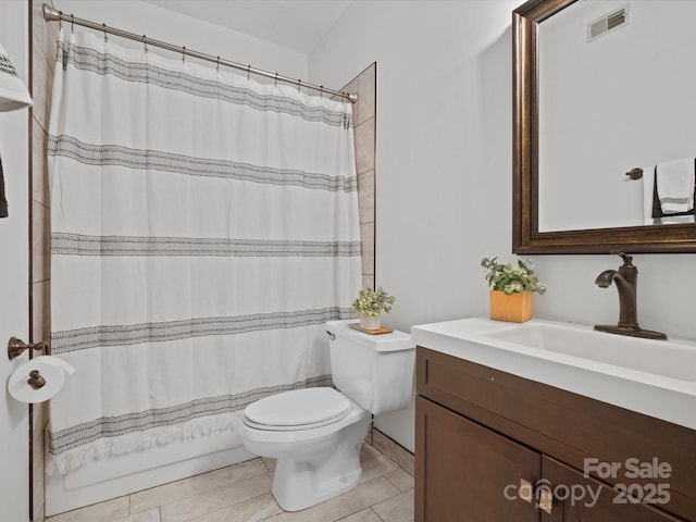 bathroom featuring tile patterned flooring, vanity, and toilet