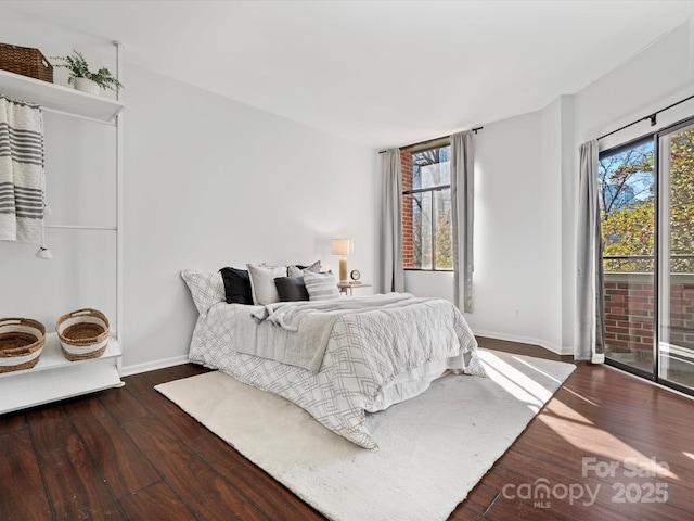 bedroom featuring dark hardwood / wood-style floors and access to outside