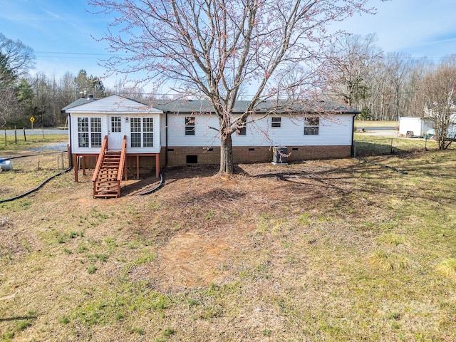 back of property with stairway, crawl space, and fence