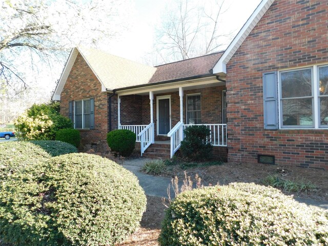 110 Robin Rd, Lincolnton, NC 28092 - view of front of property featuring a porch, brick siding, roof with shingles, and crawl space