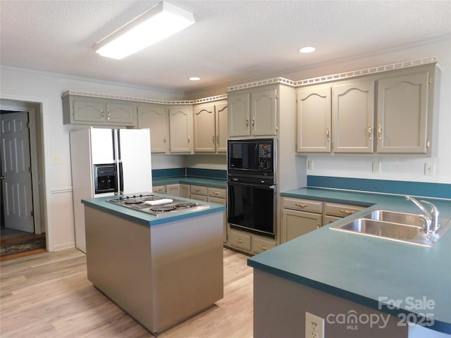 110 Robin Rd, Lincolnton, NC 28092 - kitchen featuring dark countertops, a center island, light wood-type flooring, black appliances, and a sink