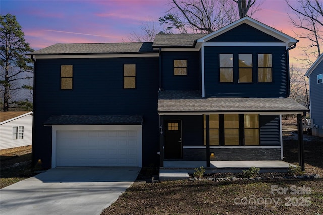 view of front of house with covered porch and a garage