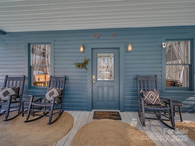 view of exterior entry with a porch