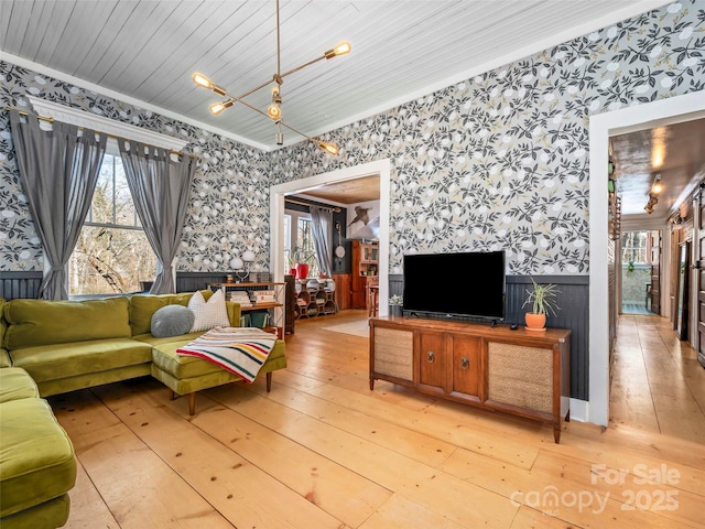 living room featuring wood ceiling, hardwood / wood-style floors, and crown molding