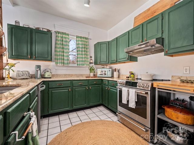 kitchen with stainless steel range with electric cooktop, green cabinetry, light stone counters, and light tile patterned floors