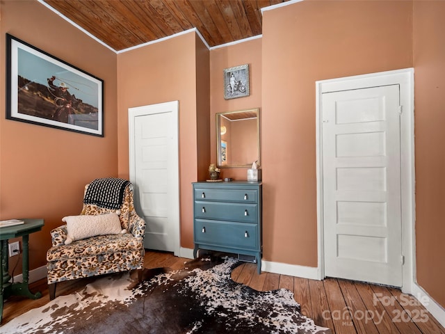 sitting room featuring crown molding and light hardwood / wood-style flooring