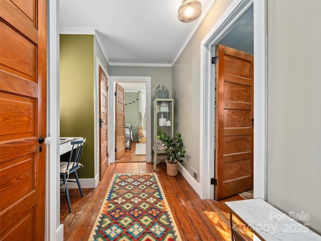 interior space featuring crown molding and wood-type flooring