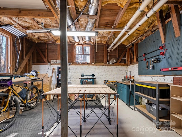 miscellaneous room featuring a workshop area and concrete floors