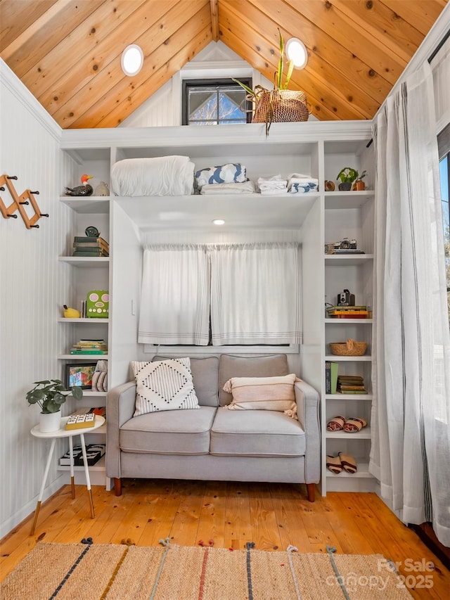 living area featuring light hardwood / wood-style floors, lofted ceiling, and plenty of natural light