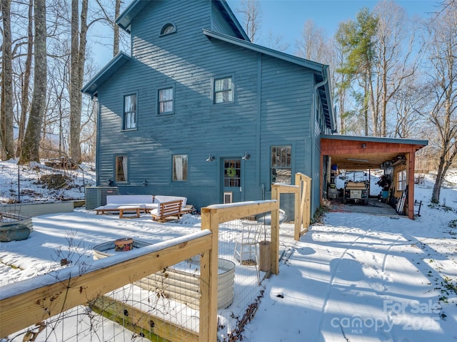 view of snow covered rear of property