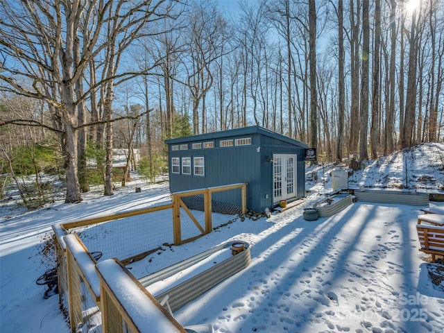 yard covered in snow with french doors