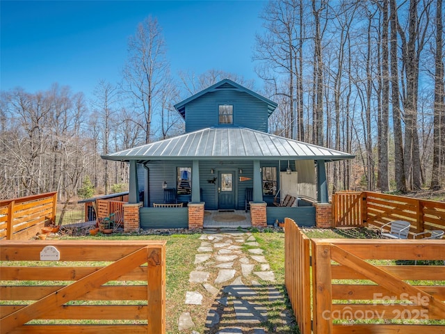 view of front of home with covered porch and metal roof