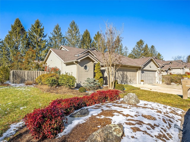 view of front of property featuring a front yard and a garage