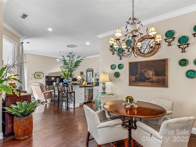 dining area featuring dark wood-type flooring, crown molding, and ceiling fan with notable chandelier