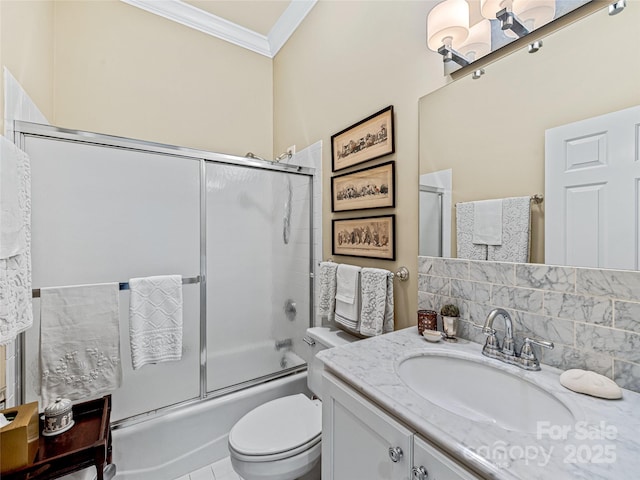 full bathroom featuring shower / bath combination with glass door, tile patterned floors, vanity, toilet, and ornamental molding