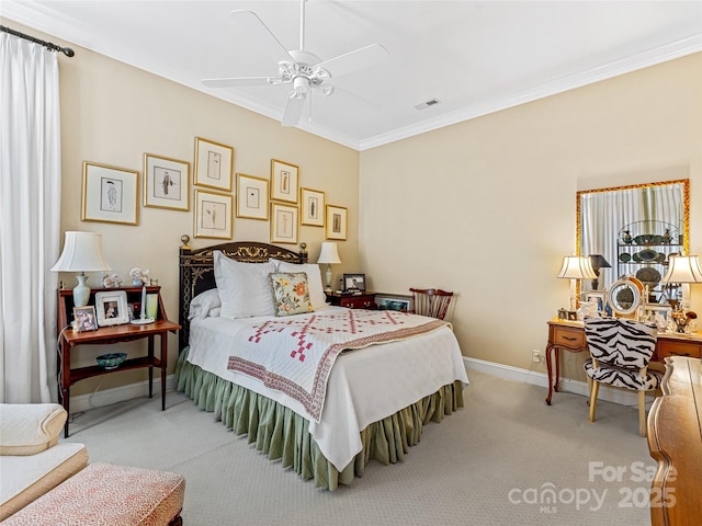 carpeted bedroom with ceiling fan and crown molding