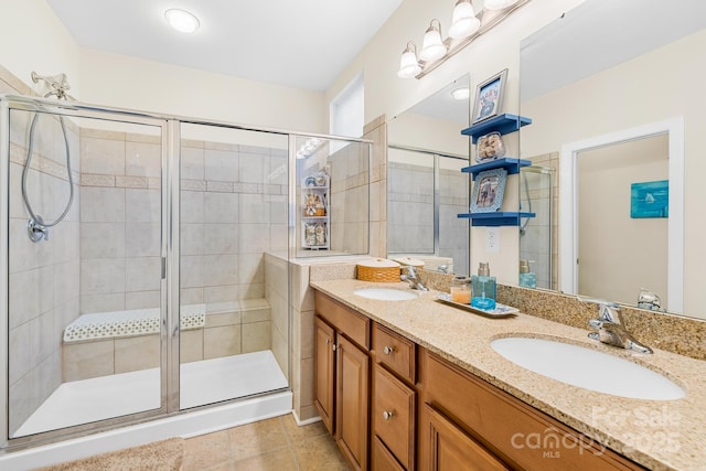 bathroom with an enclosed shower, tile patterned floors, and vanity