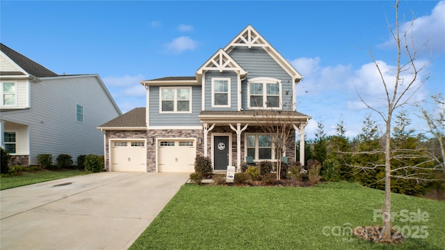 craftsman-style home featuring a front yard and a garage