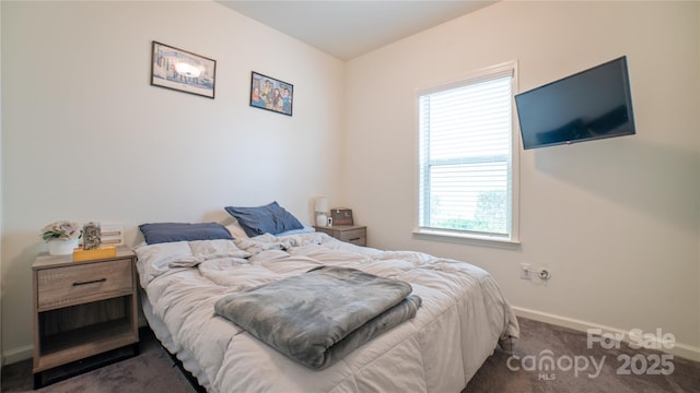 bedroom featuring dark carpet