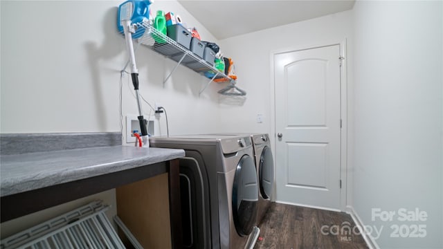 washroom with washing machine and clothes dryer and dark wood-type flooring