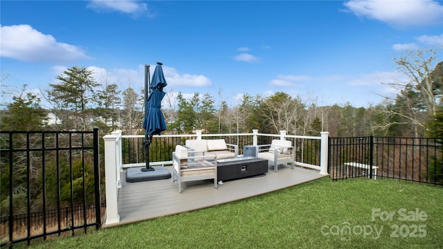 wooden terrace featuring an outdoor living space and a yard