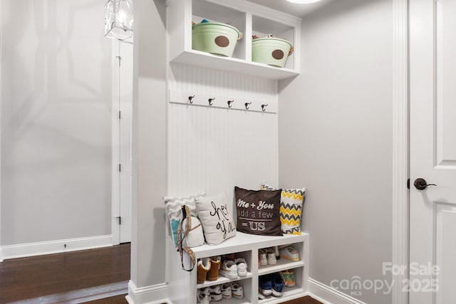 mudroom featuring baseboards and wood finished floors