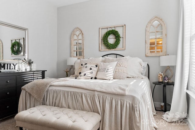 bedroom featuring carpet and baseboards