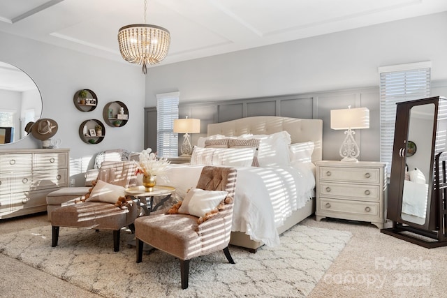 carpeted bedroom with a chandelier